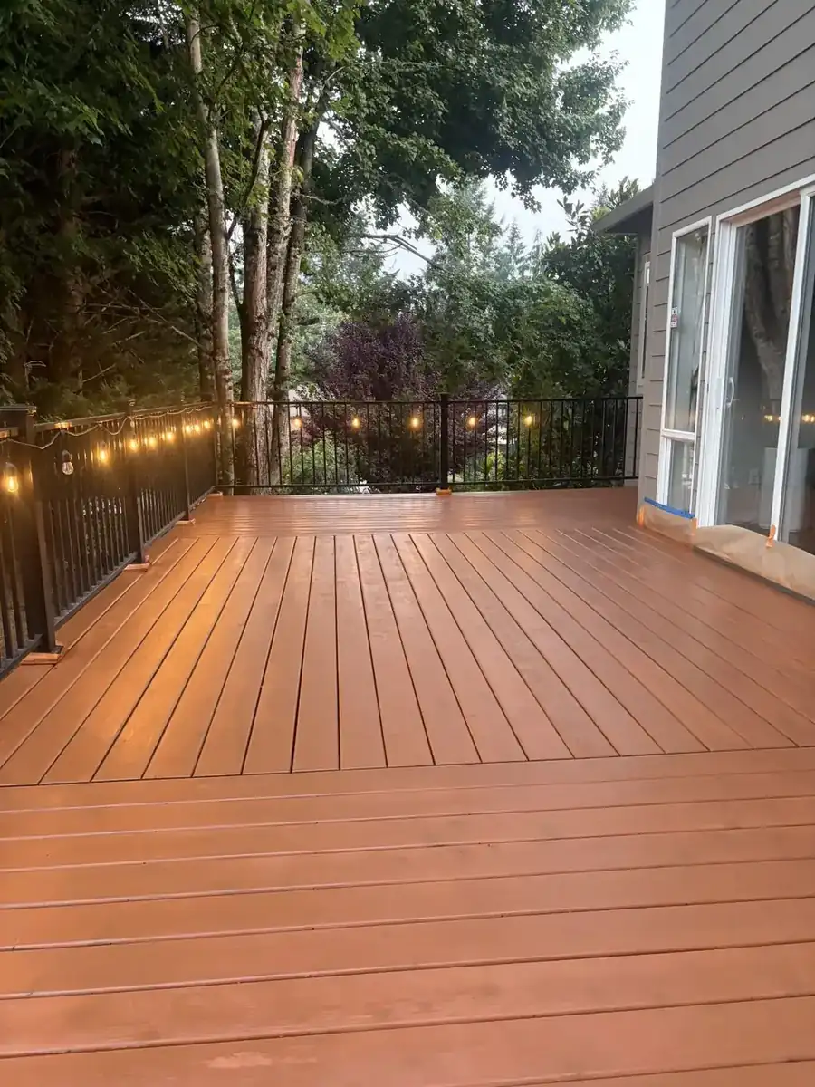 Stained wood deck with string lights along the railing