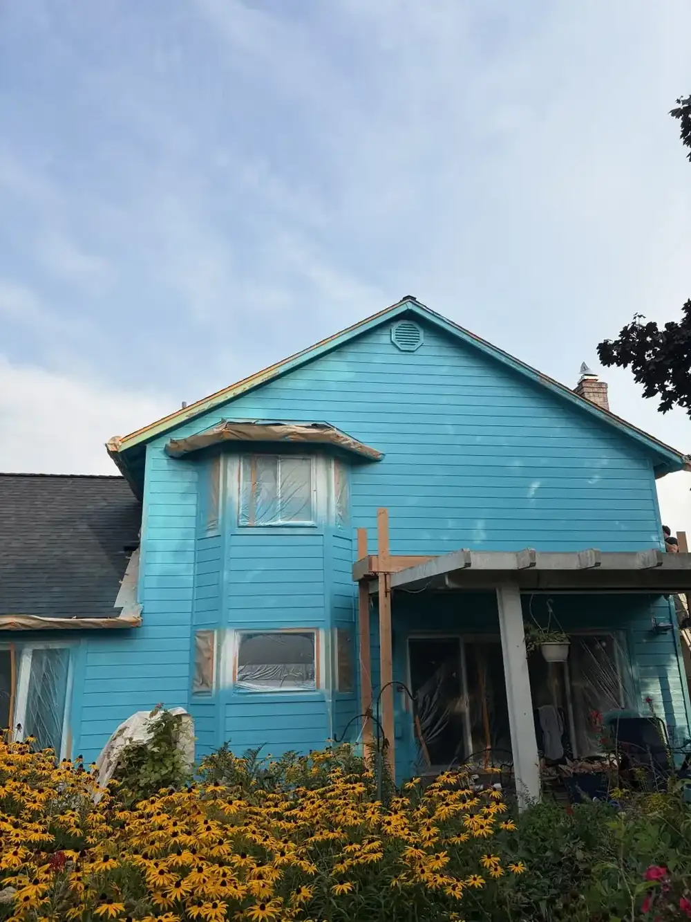 Two-story house exterior painted bright blue